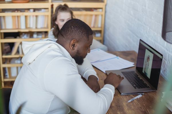 focused black male entrepreneur working on laptop
